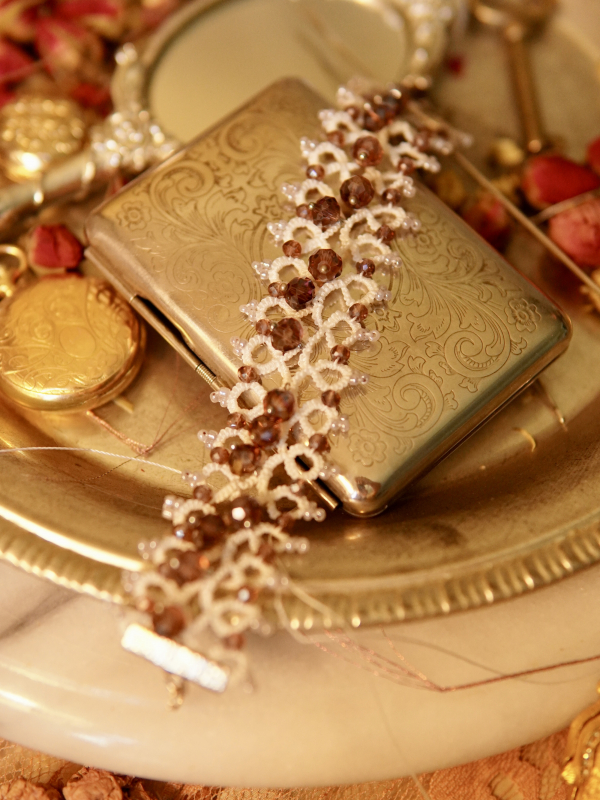 Needle-tatted bracelet in white thread with lilac beadwork and silver clasp