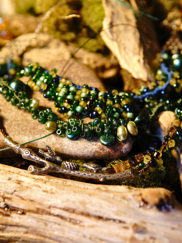 Three-strand tatted woodland necklace in brown, green, and blue hues Multi-strand woodland necklace with silver branch centerpiece