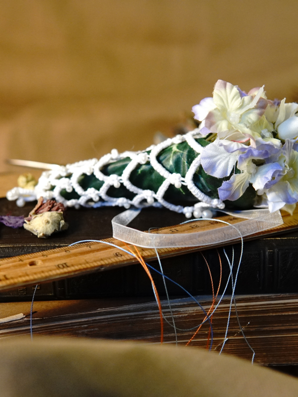 Everpetal Ornament Handmade tatted lace floral ornament displayed on stacked antique books