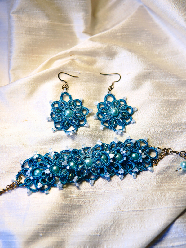 Aqua lace cuff and earrings with bead accents in soft light