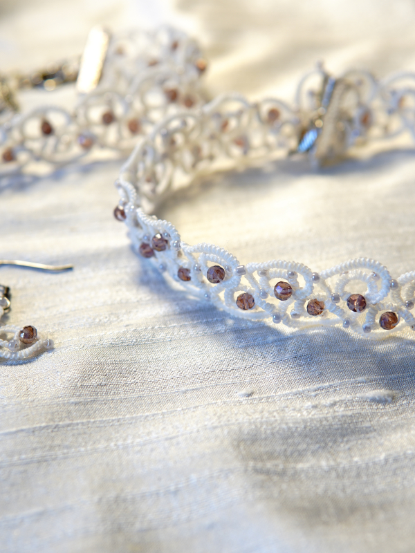 Elarian Bloom Necklace with crystals White lace choker with crystals in soft light.