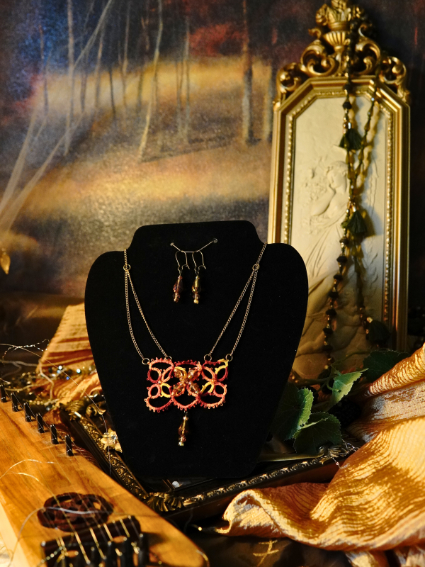 The Gilded Emberleaf tatted necklace in rust and gold Tatted rust and gold necklace displayed with complementary earrings