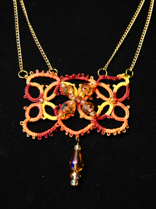 The Gilded Emberleaf tatted necklace in rust and gold Close-up of ember-toned lace centerpiece with Swarovski beads
