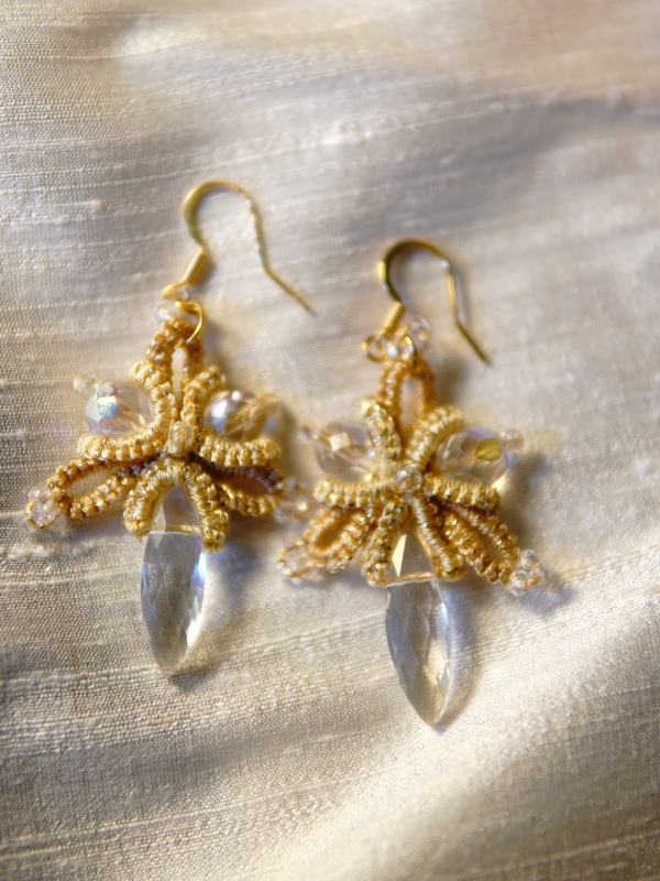 Sunstar golden tatted lace earrings with crystal drops Golden tatted earrings displayed with soft shadows