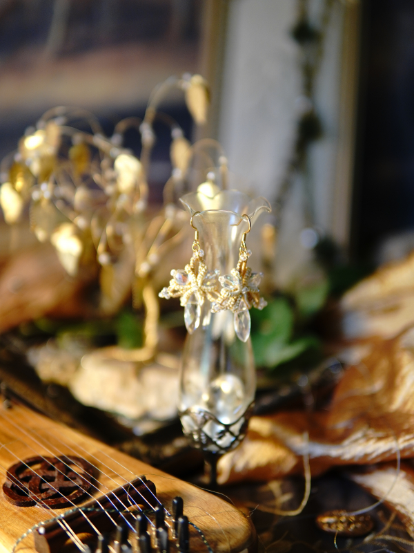 Sunstar golden tatted lace earrings with crystal drops Golden tatted earrings glowing in warm light