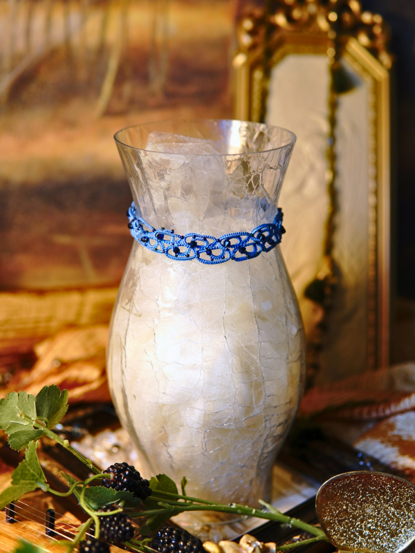 Alaria twilight blue tatted lace choker Side view of blue lace choker on display vase