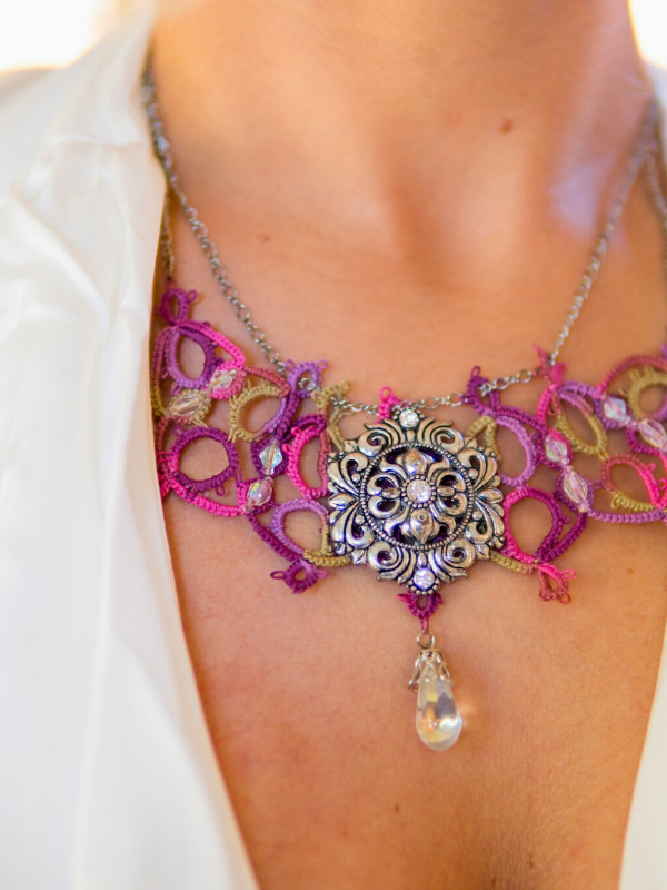 Raspberry Rain tatted necklace with silver sigil and crystal drop Bright pink and green tatted motifs framing silver centerpiece