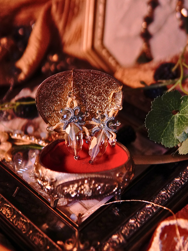 Bright sky-inspired lace earrings from Aeluin Skyglisten lace earrings displayed on red velvet