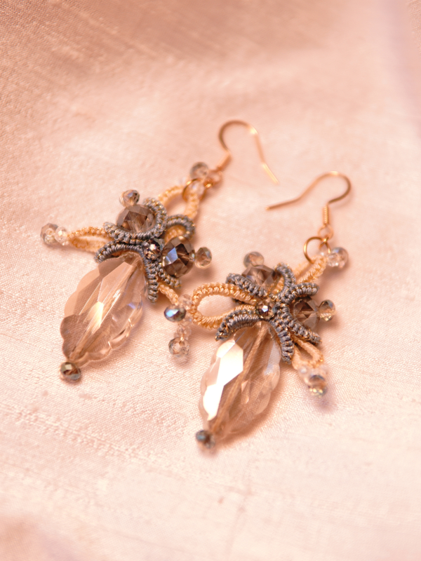 Bright sky-inspired lace earrings from Aeluin Crystal drop lace earrings on pale fabric