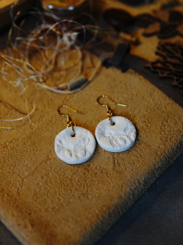 One-of-a-kind lace impression jewelry. Minimalist white statement earrings