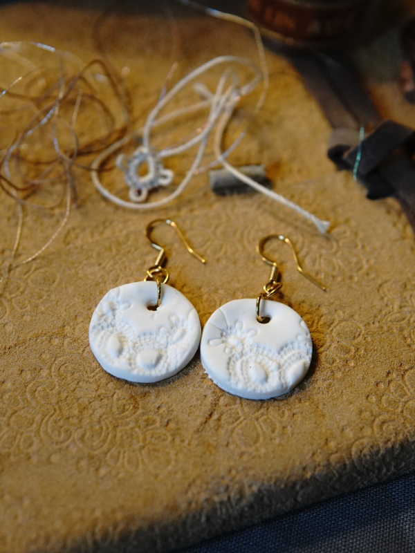 Dimensional lace pattern pressed into clay. Lightweight round clay earrings