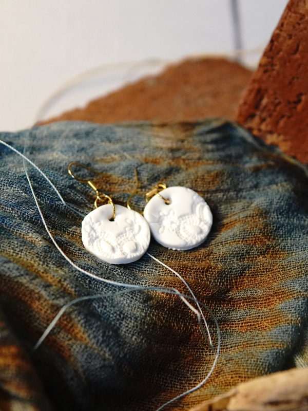 14k gold-plated ear wire detail. One of a kind white earrings