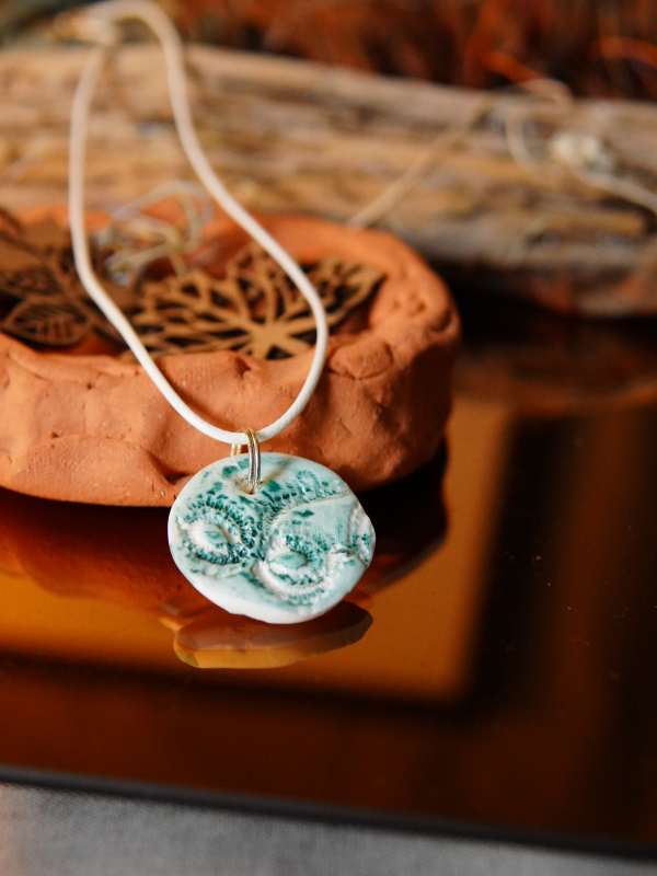 Alabaster clay pendant with green patina