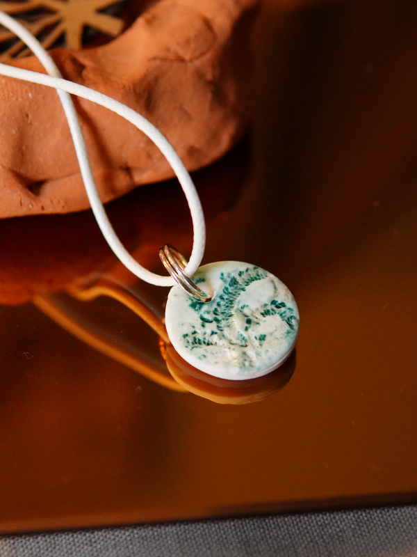 White cord small clay necklace