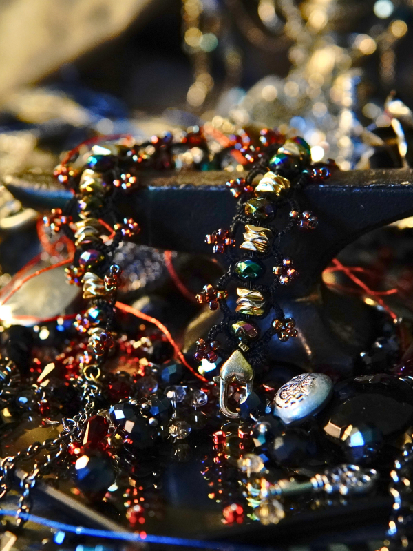 Close-up of loops, vows, and gold detail Close-up of gold and violet tatted details