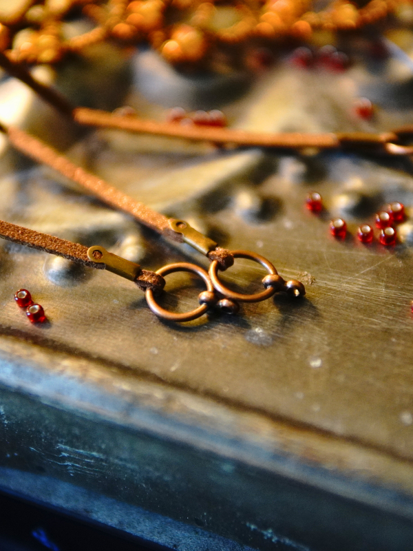 Emberbind necklace with fire-amber beadwork and leather ties Brown suede tie closure on bronze hardware