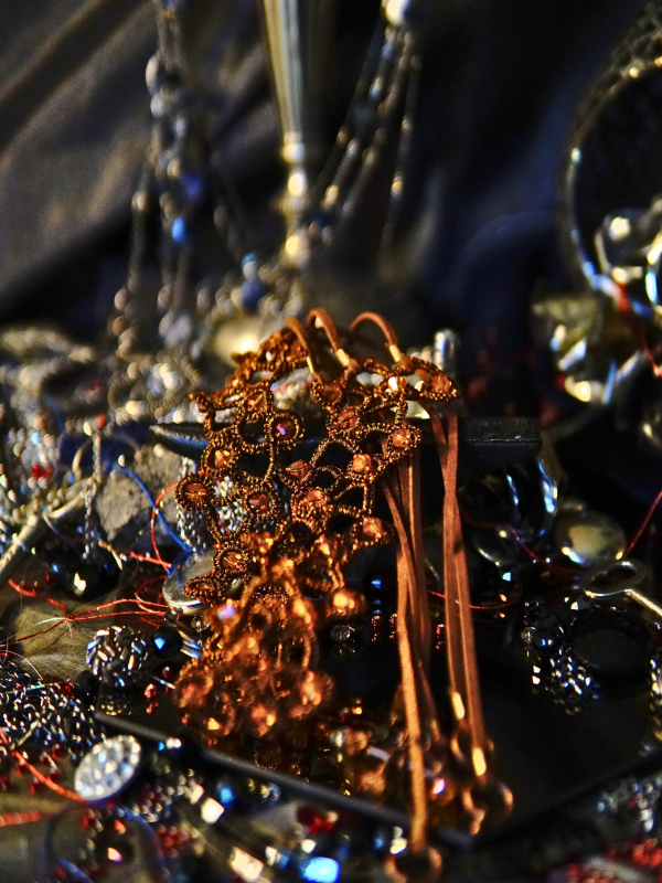 Emberbind necklace with fire-amber beadwork and leather ties Fire-toned lace centerpiece with bronze accents