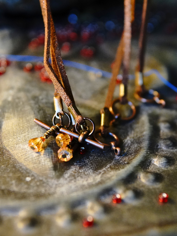 Emberbind necklace with fire-amber beadwork and leather ties Bronze toggle clasp with amber drops