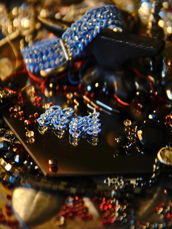 Frostwarden earrings in icy blue thread Frostwarden set on Oathforged backdrop