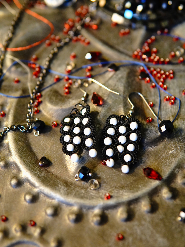 Oathforged shadow-themed earrings Close-up of black lace and white howlite beads