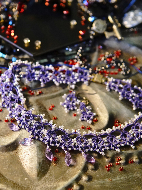 Veilborne Oracle tatted lace necklace and earrings Close view of lace loops with white and purple bead accents