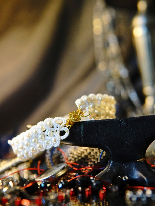 Vowguard bracelet in white lace and pearl White pearl tatted bracelet on small anvil