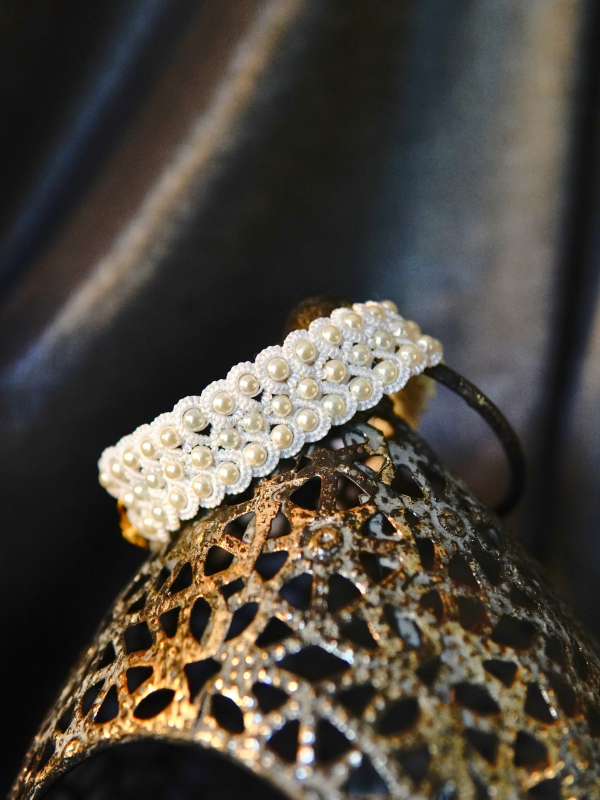 Vowguard bracelet in white lace and pearl Vowguard bracelet draped on rustic prop