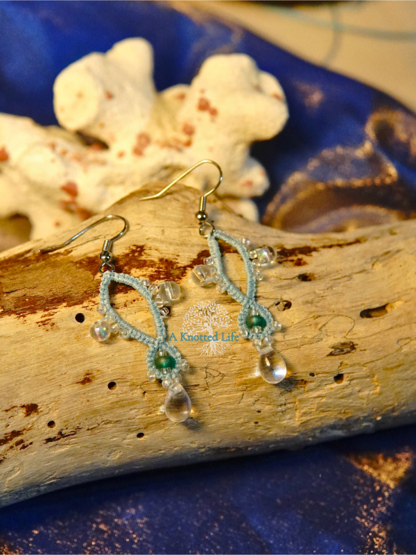Elegant tatted necklace and earrings with sea-glass tones.