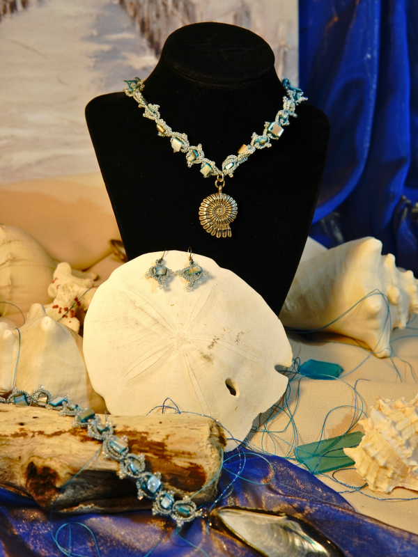 Coastal inspired jewelry set in aqua and silver with seashell beads.