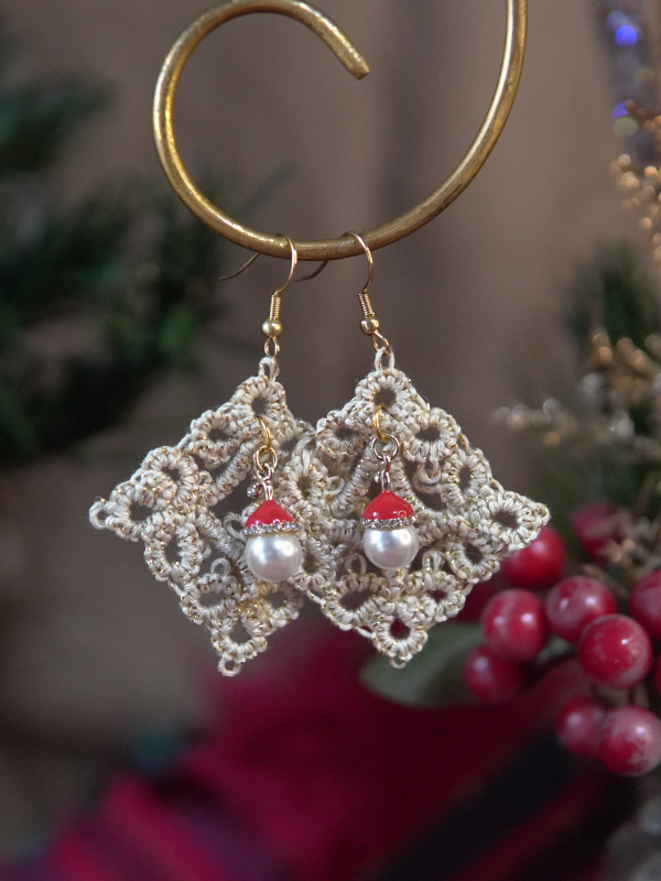 Festive tatted lace earrings featuring pearl beads topped with tiny Santa hats.