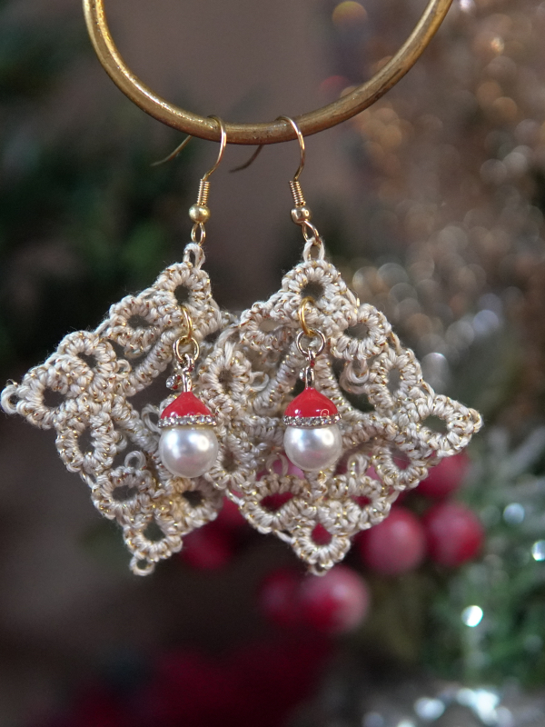 Intricate diamond lace earrings with pearl and Santa hat beads shown in festive