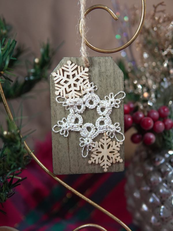 Handmade white tatted snowflake on rustic wood White lace snowflake on wooden ornament