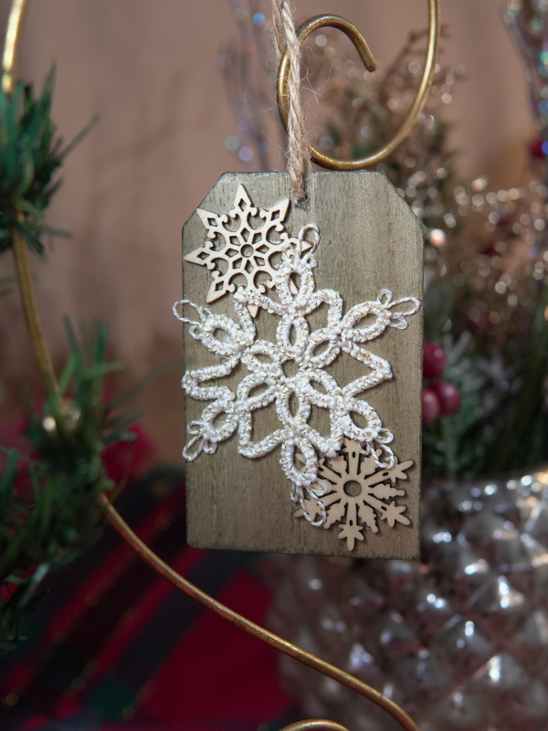 Shimmering white lace snowflake on weathered wood Rustic ornament with handmade tatted snowflake