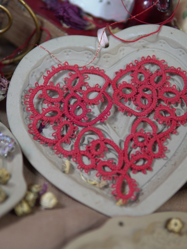 Large handmade tatted lace Valentine heart ornament Large red tatted lace heart ornament displayed on ceramic heart tray.