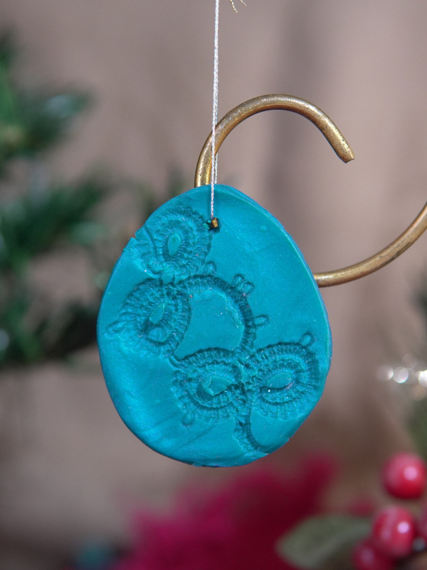 Teal handmade ornament with lace imprint and shimmer finish