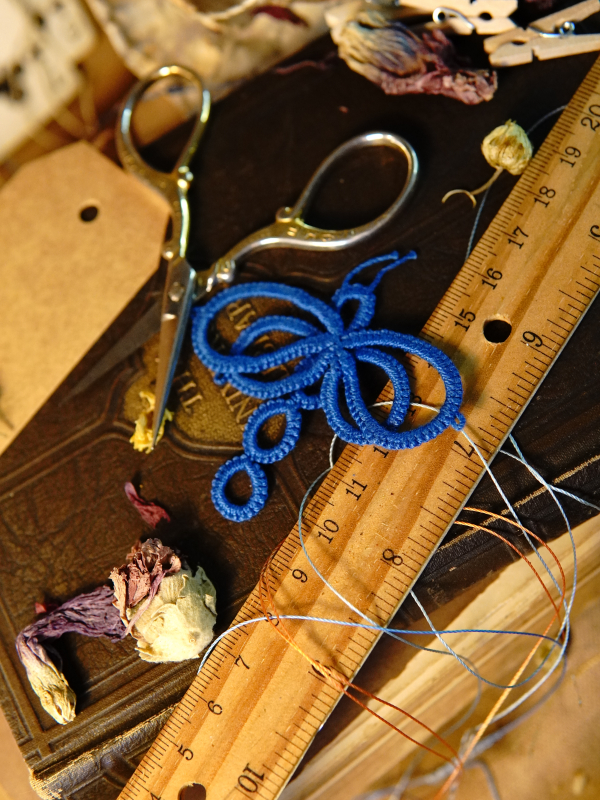 Tatted dragonfly scrapbook embellishment Small tatted dragonfly embellishment beside vintage scissors