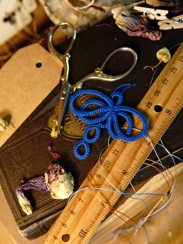 Tatted dragonfly scrapbook embellishment Blue tatted dragonfly resting on a vintage book and dried flowers