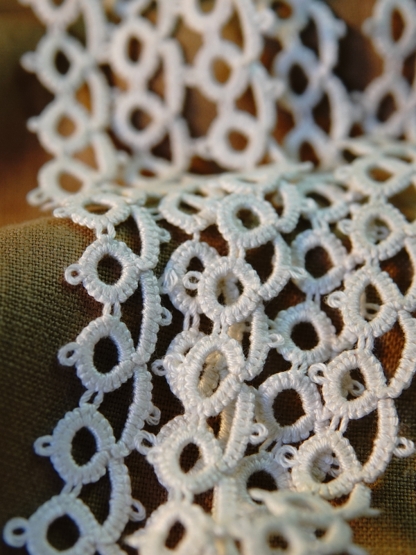 Classic Loop Lace Delicate white tatted lace loops resting against a neutral background fabric