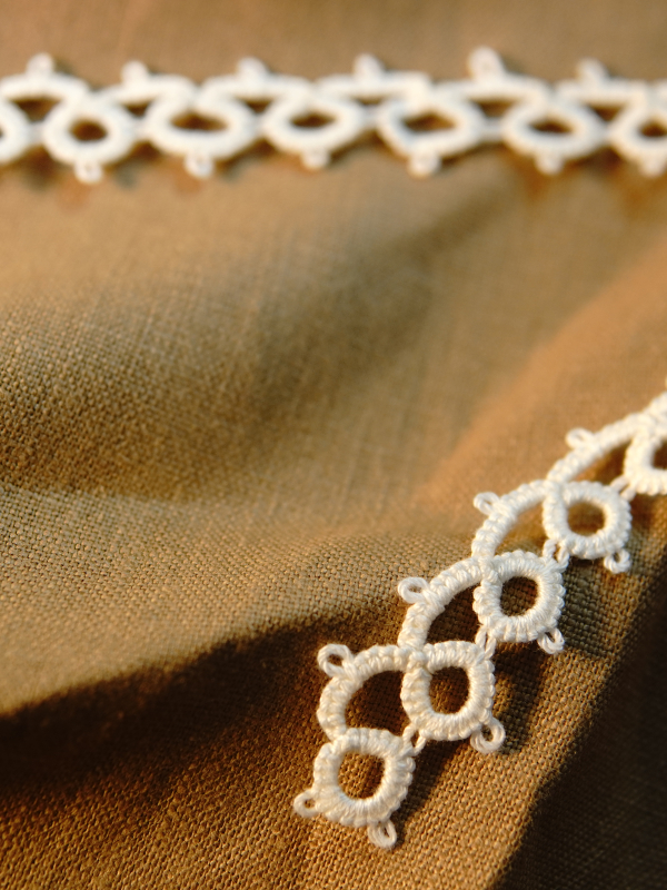 Classic Loop Lace Detail shot of hand tatted lace by the yard displayed on neutral fabric