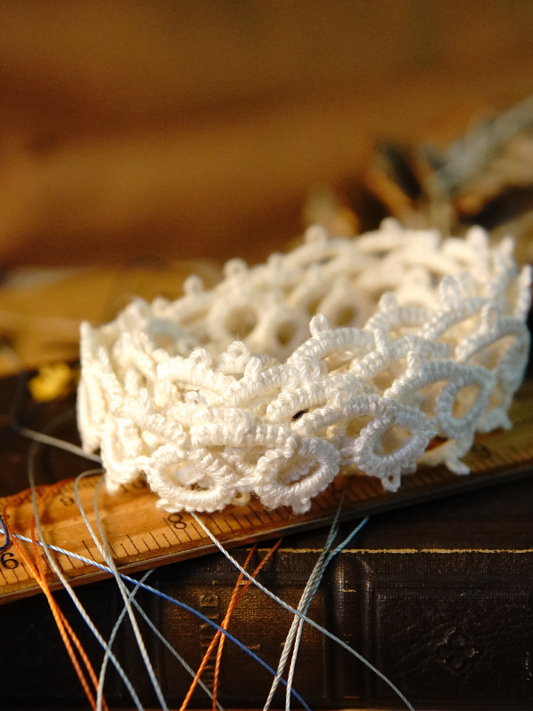 Classic Loop Lace Classic open-pattern tatted lace displayed on old books and tools