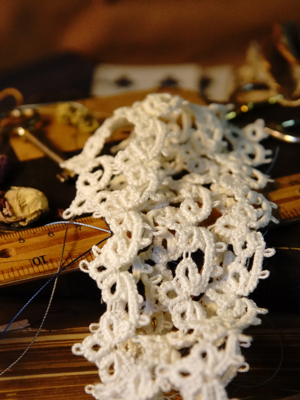 Heirloom Cluster Lace Heirloom-style white tatted lace resting on antique books and trim