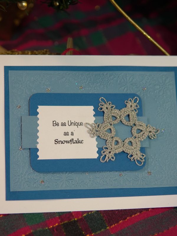 Flatlay of multiple tatted snowflake notecards showcasing four different winter