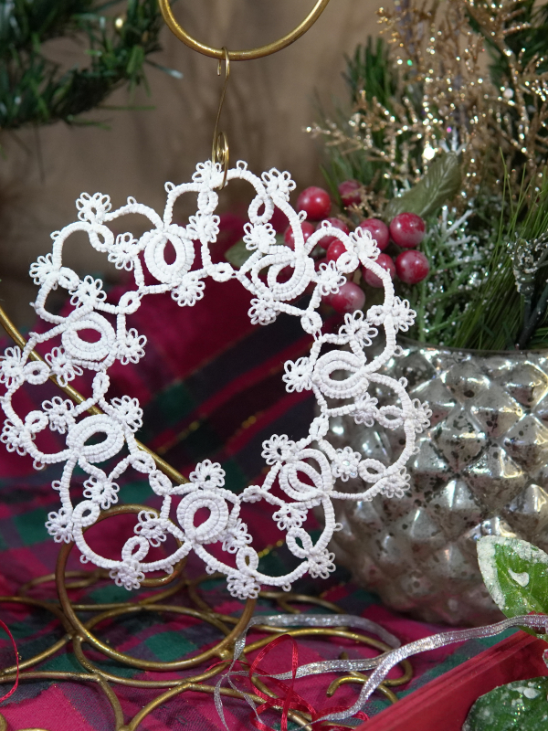 Large Christmas ornament Large tatted winter ornament hanging near holiday berries