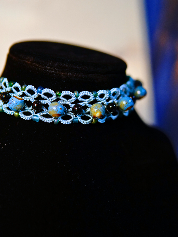 Sentinel choker with sea-glass, black beads, ceramic, and sea-blue lace.