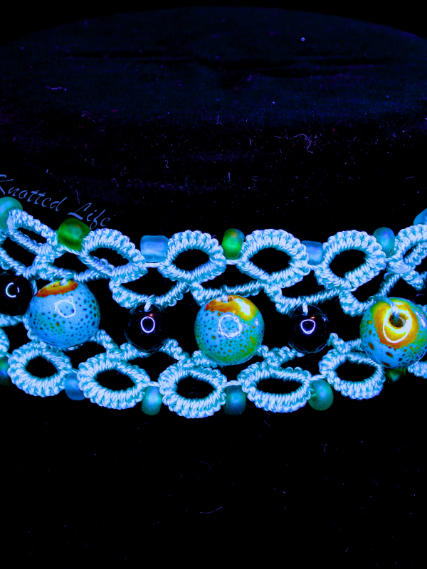 Ocean-inspired tatted lace choker with glass and ceramic beads, Celtic clasp.