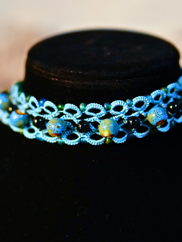 Tatted lace necklace with ceramic, black, and sea-glass beads, Celtic clasp.