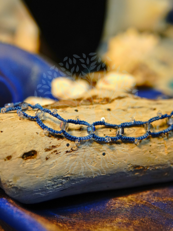 Ocean-inspired lace necklace with square-cut crystals.