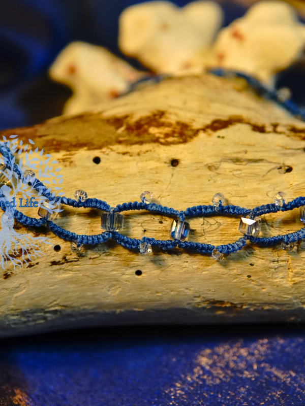 Hand-tatted lace necklace with prism-like sparkle.