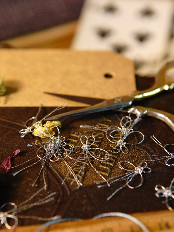 Tiny metallic tatted butterflies – set of 12 Dozen tiny tatted metallic butterflies on a craft table