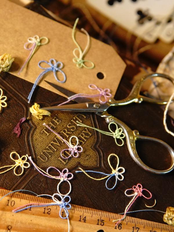 Multicolored tatted butterflies – embellishment set Multicolored tatted butterflies displayed on a craft table